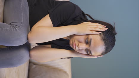 Vertical-video-of-Desperate-young-woman-with-her-hands-on-her-head.-Depressed.